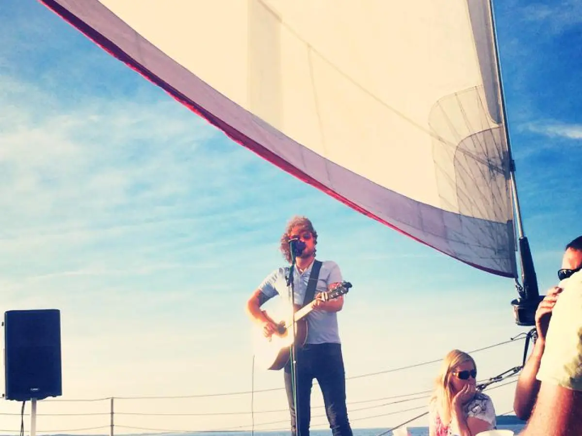 A musician playing to an audience on the Nauti-Cat