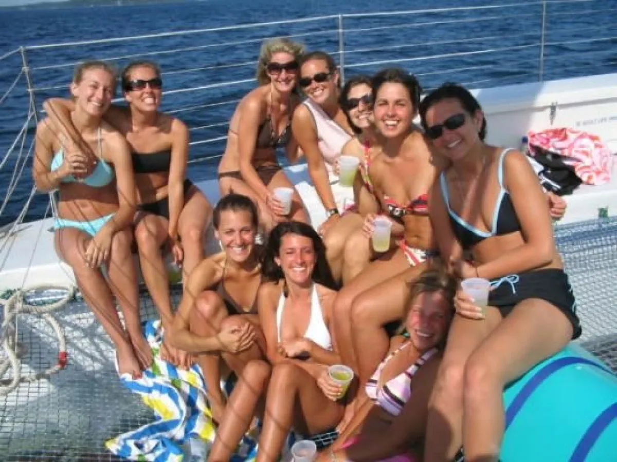 A group of women in bathing suits enjoying the warm weather on the Nauti-Cat