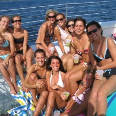 A group of women in bathing suits enjoying the warm weather on the Nauti-Cat
