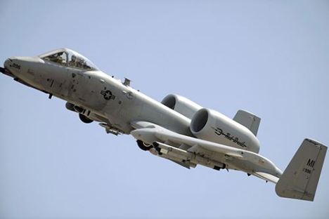a large passenger jet flying through the air on a cloudy day