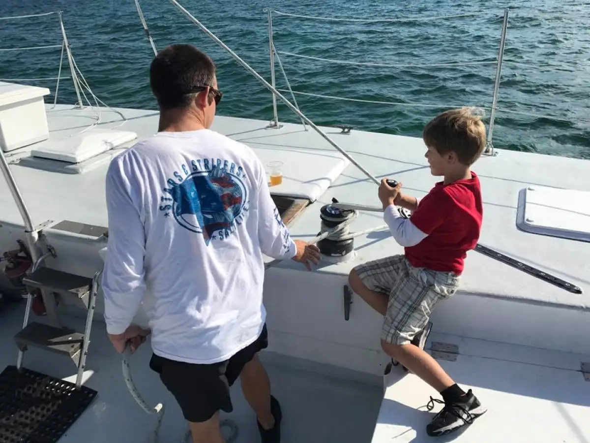 a young boy standing on a boat