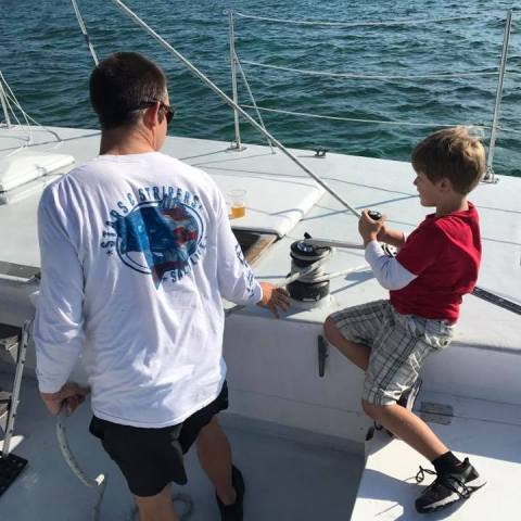 a young boy standing on a boat