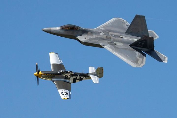 a fighter jet flying through a blue sky