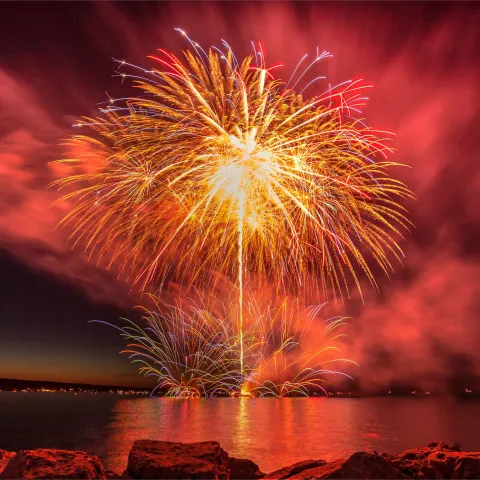 fireworks in the sky over a body of water