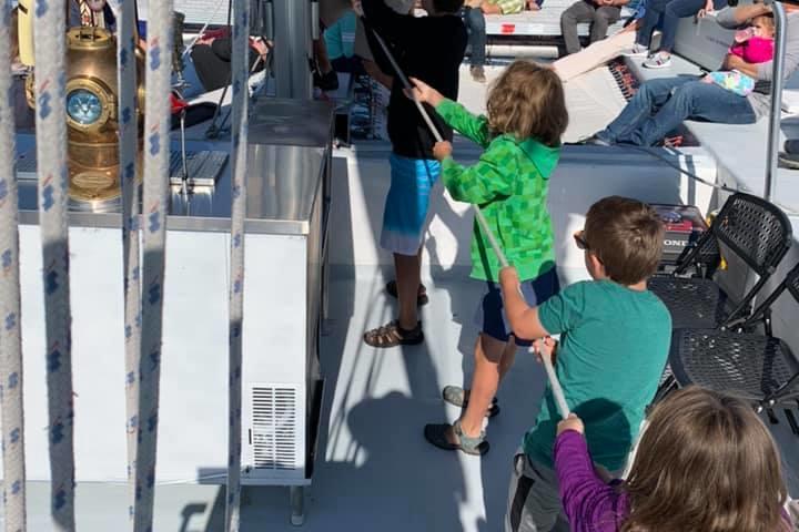 a group of people standing on a boat